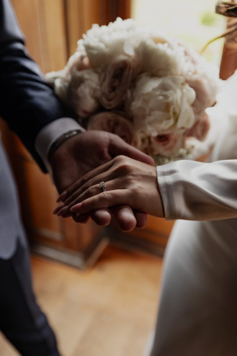 aesthetic photo of groom holding bride hand showing their wedding ring