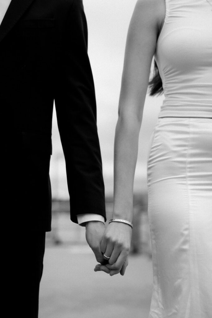 aesthetic black and white hand holding with black suit and white dress